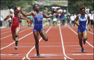 Liberty-Benton's Michaela Butler, center, won the 200-meter dash and came in second in the 100 meters.