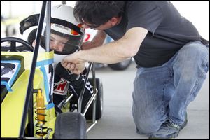 Charlie Pauken, Maumee, fist bumps his son Chuckie Pauken, 8, for good luck before he races.