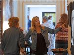  Judy Schramm, left, and Jana Duckett, both of Rossford, make their way past the pieces of fiber art hanging during this year's fiber577 show at the 577 Foundation in Perrysburg. The free show, which ran Saturday and Sunday afternoons, featured 75 pieces, live music, 