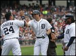  Detroit Tigers Miguel Cabrera, left, and Prince Fielder, right, congratulate Don Kelly after his three-run home run during the sixth inning against the Cleveland Indians on Sunday in Detroit.