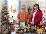  New manager Troy Sebring visits his assistant, Debbie Lake, in her booth at the Blissfield Antique Mall.