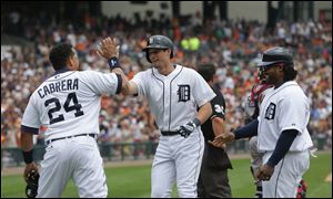 Detroit Tigers Miguel Cabrera, left, and Prince Fielder, right, congratulate Don Kelly after his three-run home run during the sixth inning against the Cleveland Indians on Sunday in Detroit.