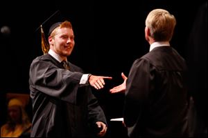 Northview graduate Julius Swolsky smiles as he receives his diploma.