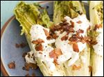  Grilled hearts of romaine with blue cheese dressing.