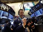  FILE-In this Tuesday, May 28, 2013, file photo, Trader Gregory Rowe works on the floor of the New York Stock Exchange. Global stocks rose Monday June 10, 2013 after U.S. jobs data helped allay concern the Fed might wind down its stimulus and Japan's prime minister promised new tax cuts. (AP Photo/Richard Drew, File)
