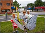  Molly Wachtmann of Whitehouse and her grandsons Luke Yokum, 9, left, and Matthew, 12, center, inspect a newly erected fiberglass butterfly in Whitehouse. The trio examined each butterfly in town.
