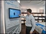  PureSleep store manager Stephen Graham enters data about a customer into a program that helps that customer find the right mattress. Mr. Graham says the store is not just about mattresses but about getting a good night’s sleep. Art Van is set to open its area superstore by summer’s end.