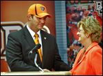  Chris Kingston, left, smiles as he is welcomed as the 13th director of athletics at Bowling Green State University by school president Mary Ellen Mazey. Kingston, who received a five-year contract with a base salary of $245,000 per year, will begin July 15.