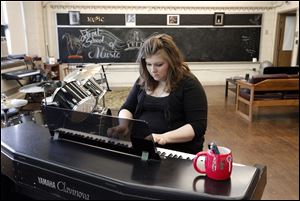 Carole Hoste, plays piano at the Detroit School of Music, a former Detroit Public School building, where she gives private music lessons.