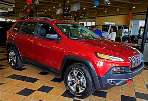 A 2014 Jeep Cherokee Trailhawk is displayed at Charlie’s Dodge in Maumee. One expert predicts sales of 80,000 to 100,000 Cherokees a year in the United States. 