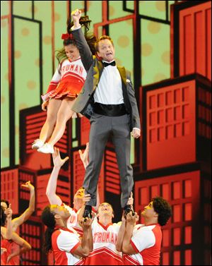 Neil Patrick Harris, who returned as emcee for the fourth time, performs with cheer-leaders for a number.
