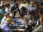  Job seekers inquire for positions at the 12th annual Mission career fair in the skid row area of Los Angeles last week.