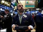  Trader Michael Hagis works on the floor of the New York Stock Exchange Tuesday, June 11, 2013. Stocks are falling in early trading on Wall Street, following global markets lower after the Bank of Japan declined to take further action to shore up that country's financial system. (AP Photo/Richard Drew)
