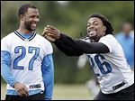  Defensive backs Louis Delmas, right, and Glover Quin laugh at minicamp Tuesday. The Lions hope to bounce back from a dismal 4-12 record last season.