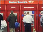  Customers use ATMs at a Bank of America branch office in Boston. A report by the Consumer Financial Protection Bureau released Tuesday said it’s hard for consumers to anticipate and avoid overdraft charges. These charges vary widely from one bank to the next, the report said.