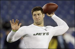 Tim Tebow warms up with his former team the New York Jets in December, 2012. 