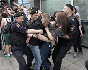 Police officers detain gay rights activists as they gathered near the State Duma, Russia's lower parliament chamber, in Moscow, Russia, today in protest.