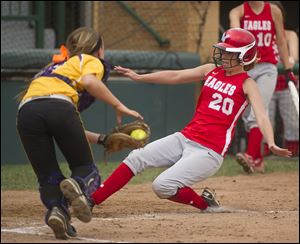 Eastwood’s Morgan Corns scores ahead of the tag by Bloom-Carroll catcher Kipley Detwiler in the Division III state semifinals. The Eagles were 29-4.