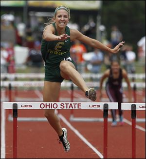 Evergreen junior Carly Truckor races to a victory in the 300-meter hurdles in the Division II state track meet.