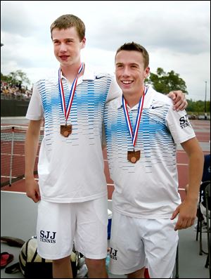 Brothers Kevin, left, and Ryan Brown of St. John’s receive their medals after finishing fourth in doubles at the Division I state tournament.