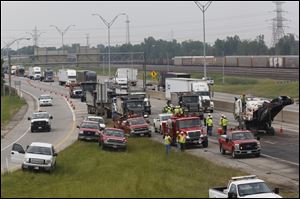 Crews work to repair a portion of northbound I-75 in North Toledo this afternoon after a crash early today  just south of Ottawa River Road. Long traffic back-ups continue as crews work on two out of the three lanes.