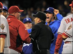 Los Angeles Dodgers starting pitcher Clayton Kershaw, right, yells as Arizona Diamondbacks manager Kirk Gibson, left, as umpire Clint Fagan separates them after Los Angeles Dodgers' Zack Greinke was hit by a pitch during the seventh inning Tuesday night in Los Angeles.