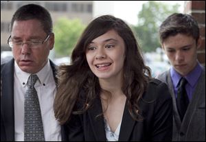 Transgender student Nicole Maines, center, with her father Wayne Maines, left, and brother Jonas, speaks to reporters.