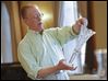  Insured Professional Antique Appraiser Richard Stegman discusses the value of a hand-cut Libbey Glass vase as he offers appraisals on objects brought by local residents to the DeGage Jazz Cafe during the Maumee Valley Historical Society fund-raiser.