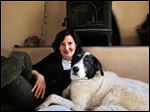  Heidi Schulman relaxes with her rescue dog, Bosco, in Santa Fe. Bosco inspired her to develop 