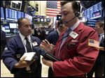  In this Monday, June 10, 2013 photo, traders Joel Lucchese, left, and Brandon Barb confer on the floor of the New York Stock Exchange. Global stock markets endured sharp losses Thursday June 13, 2013 as gyrations on the Tokyo market, the Asian region's biggest, continued _ fueled by worries about a surging yen and monetary policies in the U.S. (AP Photo/Richard Drew)