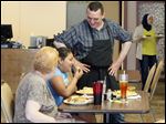  Kareem Abbey, right, owner of the Alexandria Diner, speaks with customers Joy Flansburg, left, and Amelia Lampkin, center, 10, from Sylvania, while they have lunch.