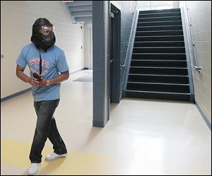 Jesse Duckworth, assistant principal at Bowsher High School, takes the role of shooter in an exercise at Woodward High School on Thursday.  In­stead of lock­ing rooms and hid­ing, school staff learn to re­act to an intrusion based on pre­sented in­for­ma­tion. Eventually students will receive training.