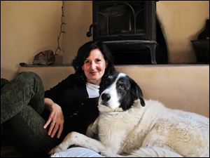 Heidi Schulman relaxes with her rescue dog, Bosco, in Santa Fe. Bosco inspired her to develop 