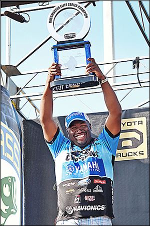 Ish Monroe lifts the Bassmaster Elite Series trophy after winning the tournament on Florida's Lake Okeechobee in 2012.