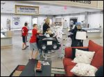   Customers shop at the Kroger store in Lambertville, which includes Fred Meyer Jewelers and furniture.