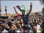  Egyptian Salafis shout slogans against Syrian President Bashar Assad as one waves a Syrian revolutionary flag during a rally after the Friday prayers at Amr Ibn Al As mosque, in Cairo, Egypt.