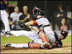  The Indians' Drew Stubbs, right, scores while the Nationals' Kurt Suzuki tries to make the play in the ninth inning.