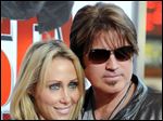  Billy Ray Cyrus, at right, and his wife Laeticia 