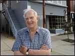  John Galbraith poses in front of his building at 117 W. Wayne Street in Maumee. The city has deemed the Greek Revival building structurally unsound and ordered that it be demolished unless Mr. Galbraith can rehabilitate it to bring it into compliance with city building codes. 