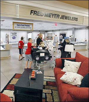  Customers shop at the Kroger store in Lambertville, which includes Fred Meyer Jewelers and furniture.