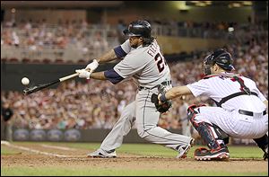 Detroit Tigers' Prince Fielder  hits a two-RBI double against Minnesota Twins starting pitcher Scott Diamond as Joe Mauer, right, waits for the pitch during the sixth inning in Minneapolis.