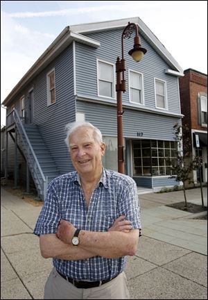 John Galbraith poses in front of his building at 117 W. Wayne Street in Maumee. The city has deemed the Greek Revival building structurally unsound and ordered that it be demolished unless Mr. Galbraith can rehabilitate it to bring it into compliance with city building codes. 