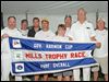  Rear commodore John Sokol, left, and vice commodore Tom Kaintz, second from right, present a flag to the winning crew of the Governor’s Cup after the Mills Trophy Race. Crew members include, beginning second from left, Tom Morgan, Steve King, John Bollin, Robert Bollin, Joe DiMasso, and Bill Bollin, far right.