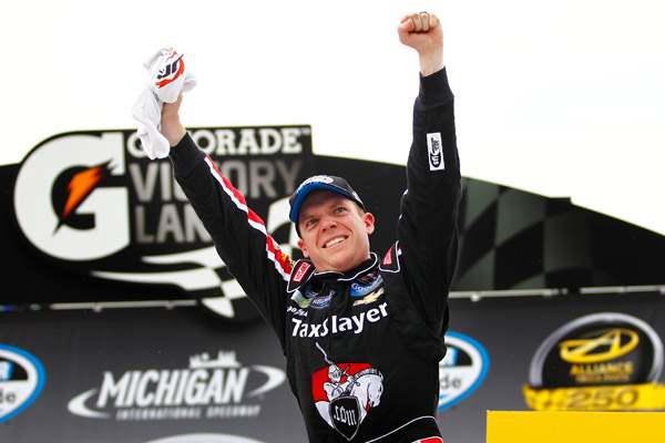 Regan-Smith-gets-out-of-his-car-and-celebrates-after-winning