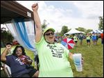  Debie Brakke of Adrian raises a cheer during the second annual Middle Class Survival Rally in Monroe on Saturday.
