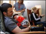  Chad Bingley holds his daughter, Kyra Ryan, shortly before she was discharged from the neonatal intensive care unit at Mercy Children's Hospital.