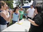  From left, Denise Yanez of Oregon, Debbie Russeau of Toledo, Heather Walker of Maumee, Amy Hofner of Bowling Green, and Todd Galpal of Toledo are assigned to a team as Risa Smith, right, coordinates search groups Saturday in East Toledo. 