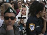  An Israeli Jewish woman of the Women of the Wall organization prays while wearing a prayer shawl at the Western Wall.