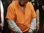  Ariel Castro walks into the courtroom for his arraignment Wednesday, June 12, 2013, in Cleveland. Castro, accused of holding three women captive in his Cleveland home for about a decade, pleaded not guilty Wednesday to hundreds of charges, including rape and kidnapping. He is charged with kidnapping three women and keeping them _ sometimes restrained in chains _ along with a 6-year-old girl he fathered with one of them.  (AP Photo/Tony Dejak)