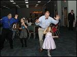  Dads and daughters do the Cupid Shuffle at a dance last fall at Owens Community College.